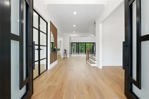 Entry hallway with wood floors and dark framed doors