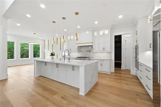 Kitchen with white cabinetry and a broad island