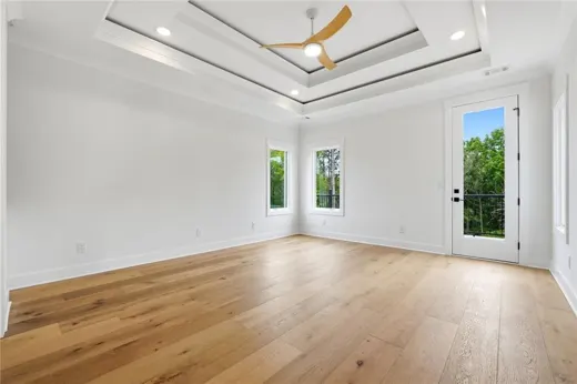 Large unfurnished bedroom with wood flooring